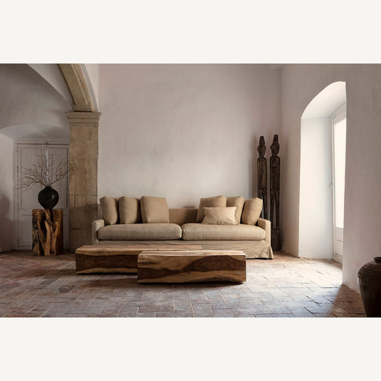 Vicalhome artistic home decor pieces featuring a stylish sofa and unique wood sculptures in a modern living space