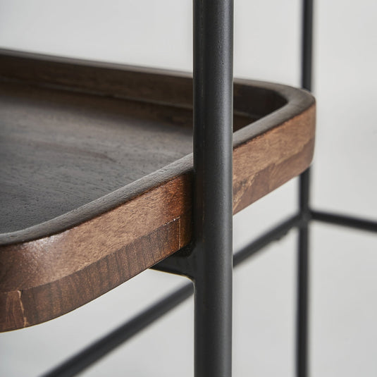 Close-up of a wooden console table with shelves showcasing a sleek wood and metal design